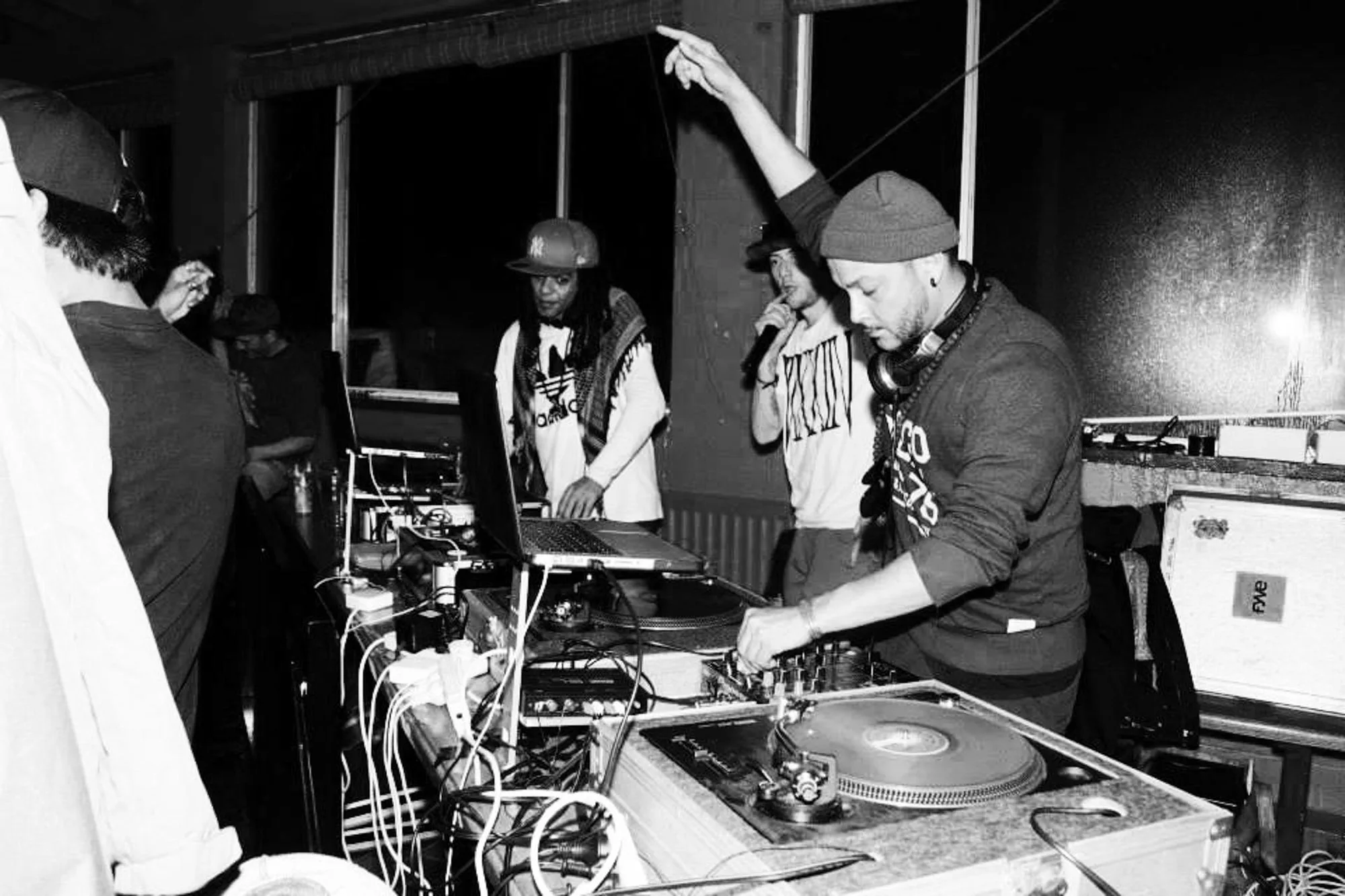 DJ CMAN back-to-back on the mixer, black and white