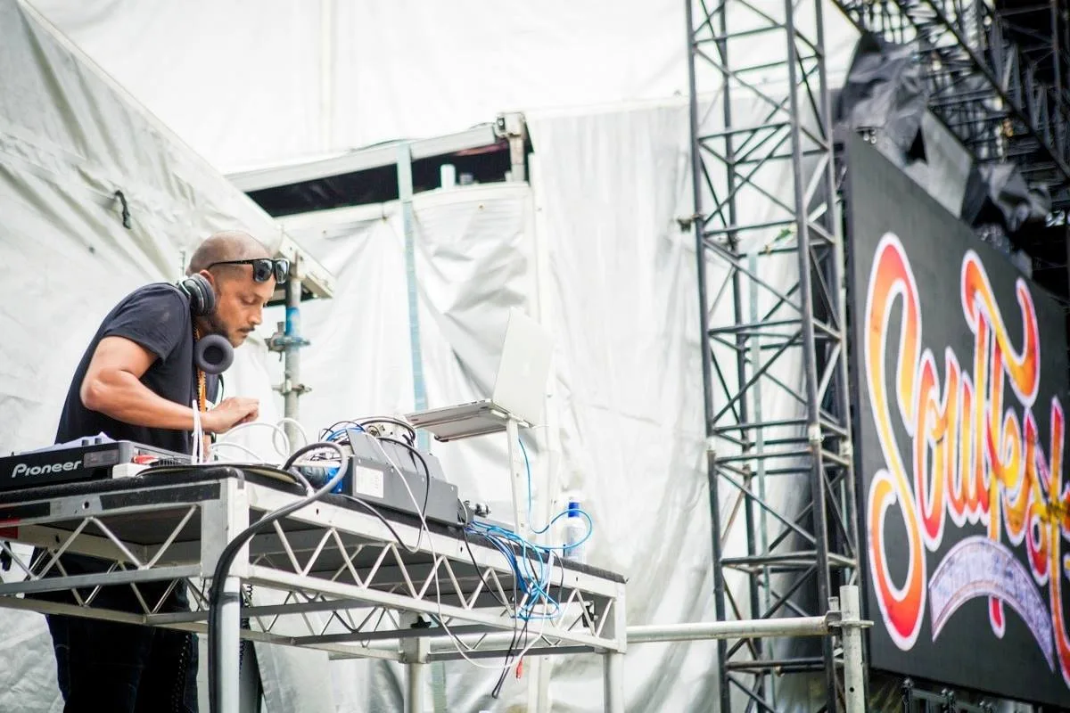 DJ CMAN behind the decks on the Soulfest stage, festival branding lit up behind him