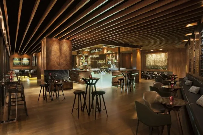 The lounge room at Grain Bar, Four Seasons Hotel Sydney, home of DJ CMAN's residency, with timber ceiling battens and bar stools