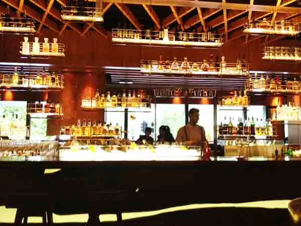 The lit bar and bottle shelves at Grain Bar on George Street, Four Seasons Hotel Sydney, home of DJ CMAN's residency