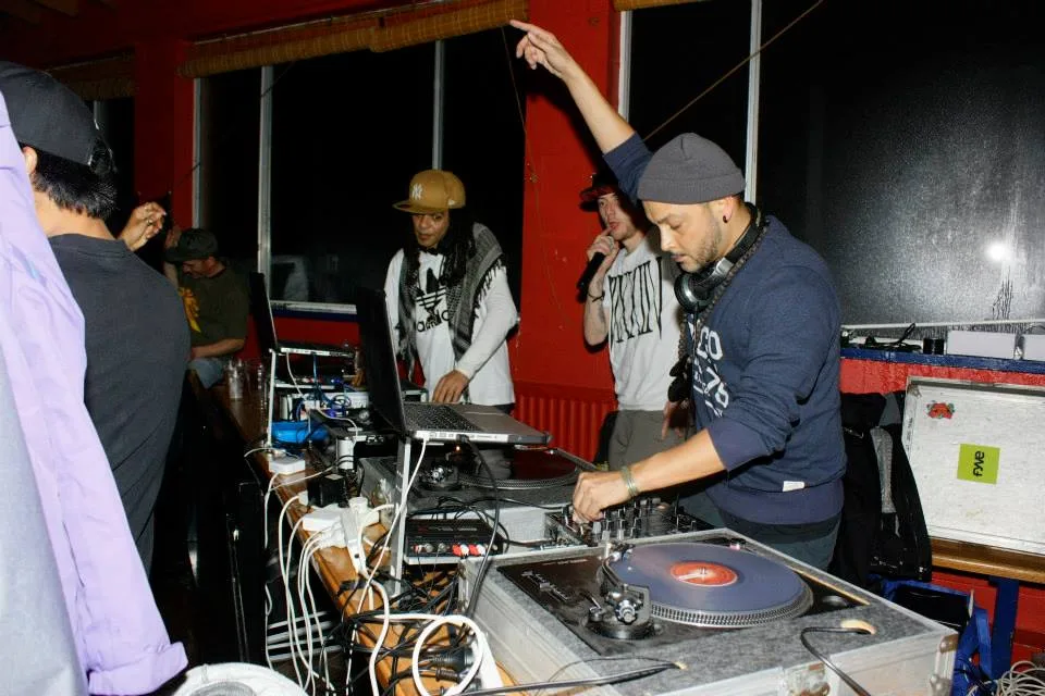 Two DJs side by side behind the turntables at the snow jam