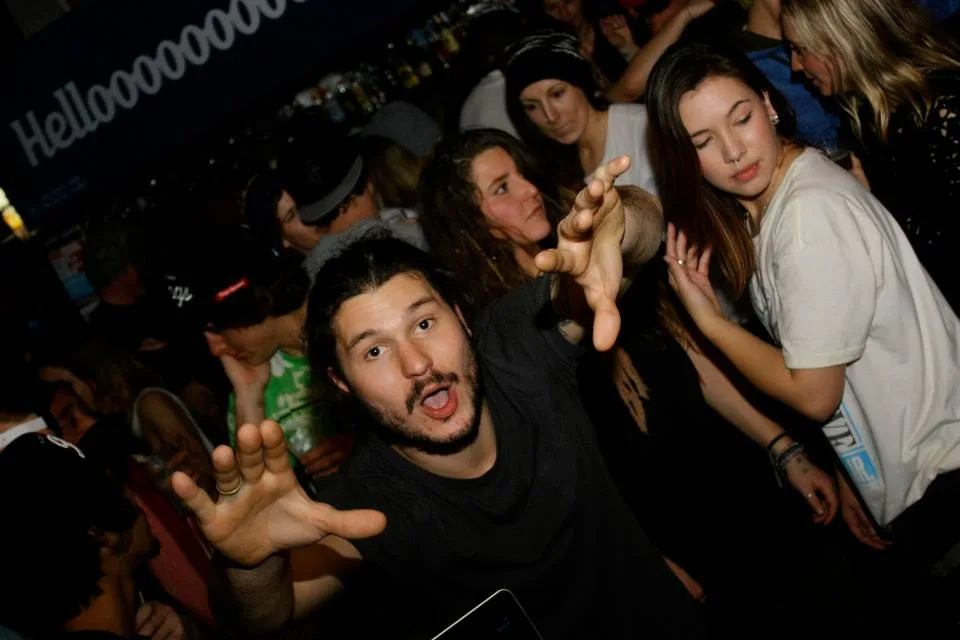 Party-goers packed in together, drinks up, at the Falls Creek snow jam