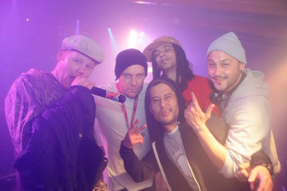 A group of friends crowded together for a photo at the Hijack Party