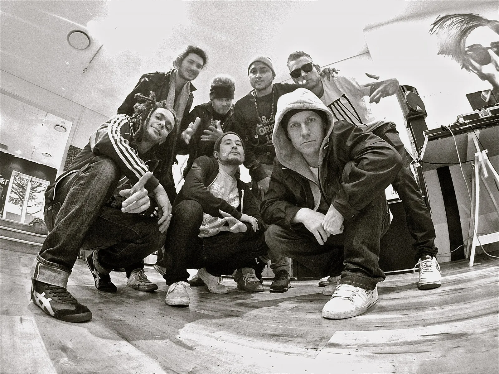 The Snow Tour crew crouched together for a black and white group portrait