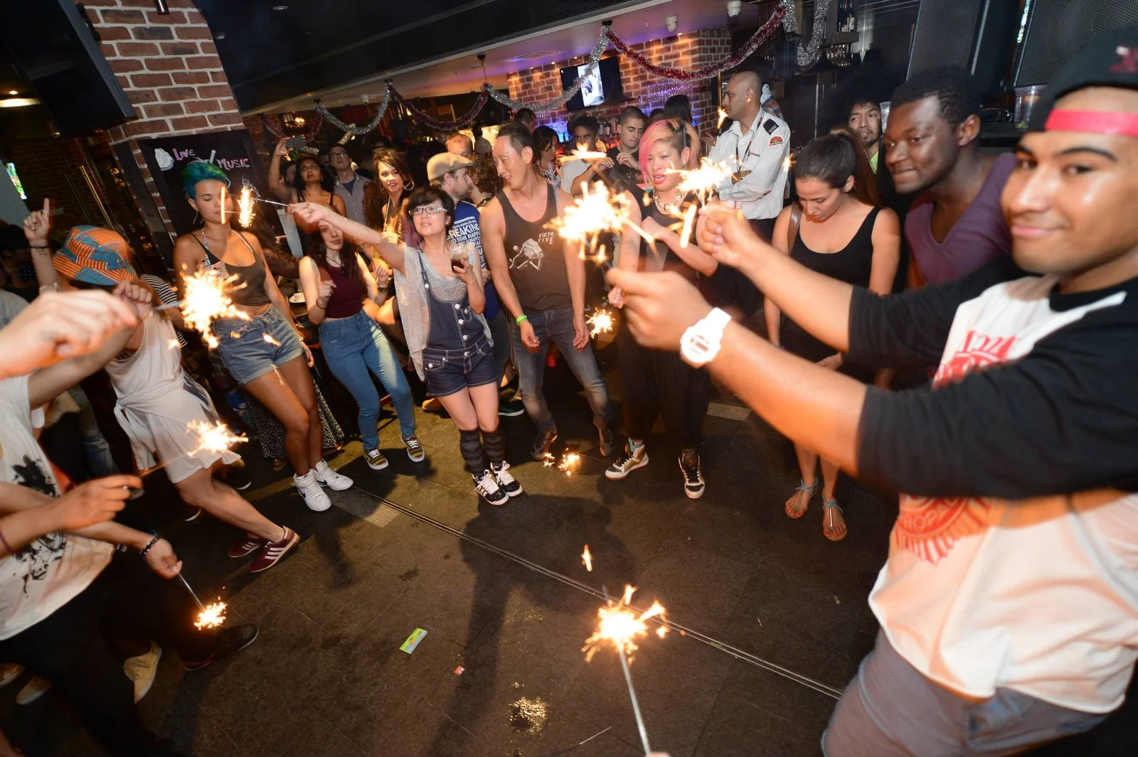 Photo from the Soul of Sydney NYD Block Party, Wednesday 1 January 2014, party-goers holding lit sparklers on the dancefloor.