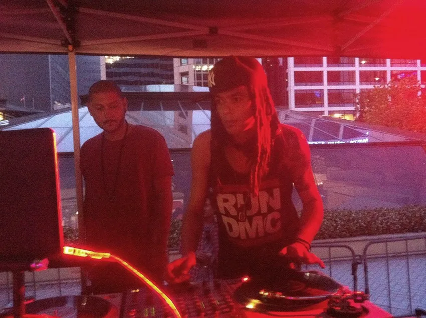 Two DJs working the decks side by side at the Greenwood Hotel