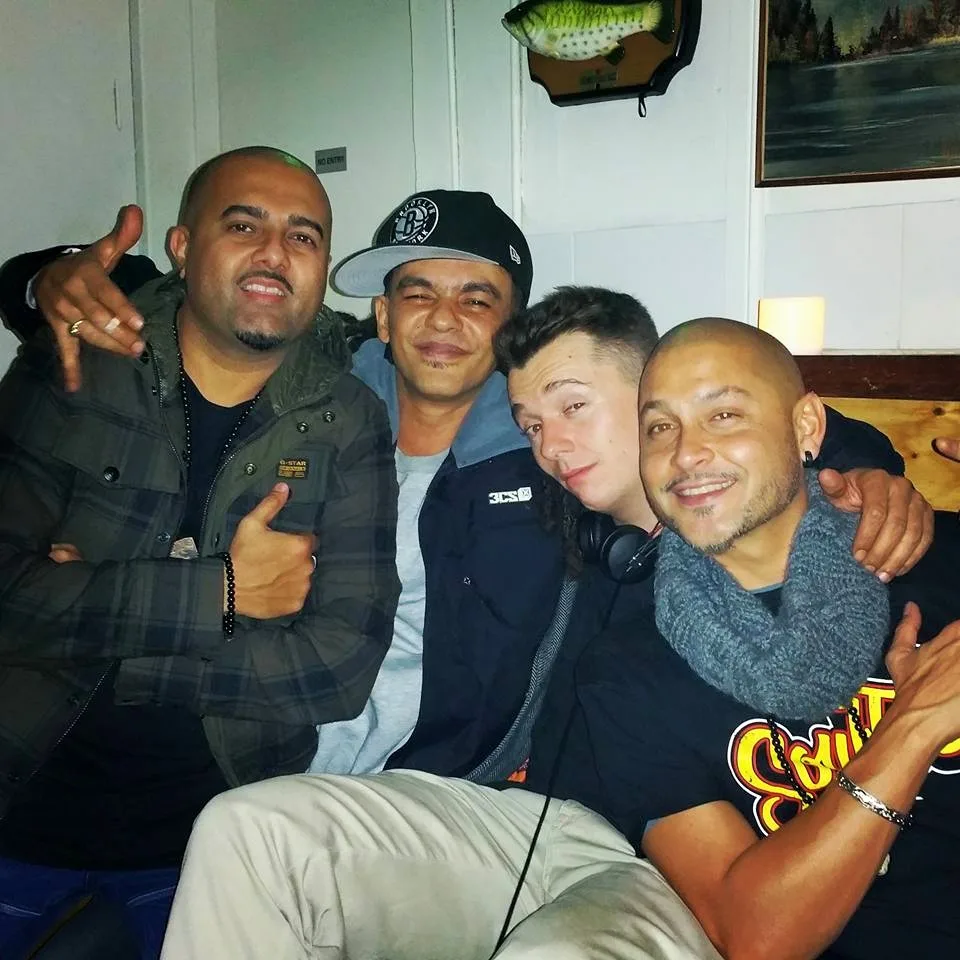 Four DJs crowded together for a photo at the Friday Sessions