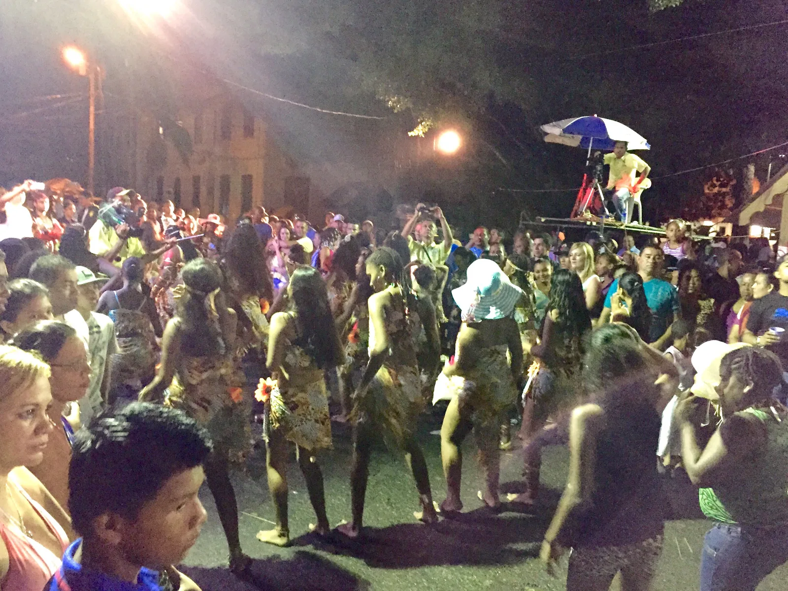 A night-time street party crowd in Central America