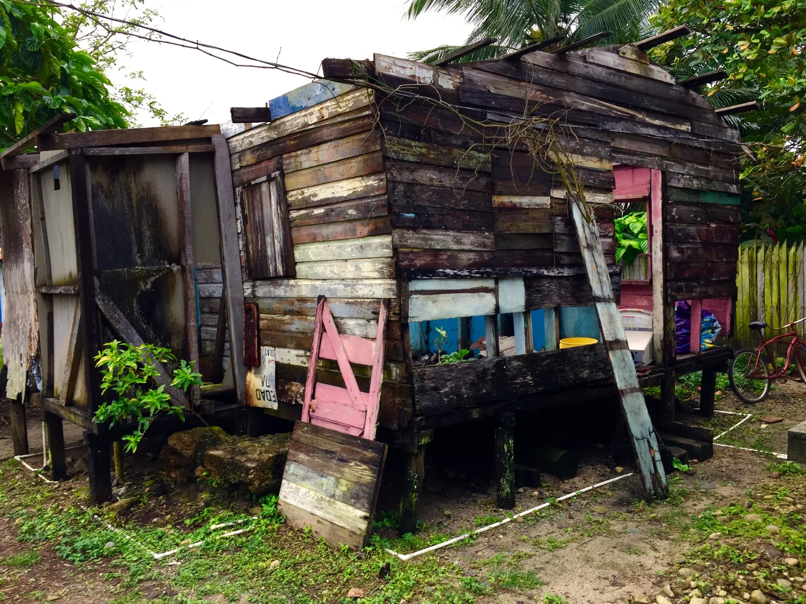 Weathered timber houses beside a road in Central America