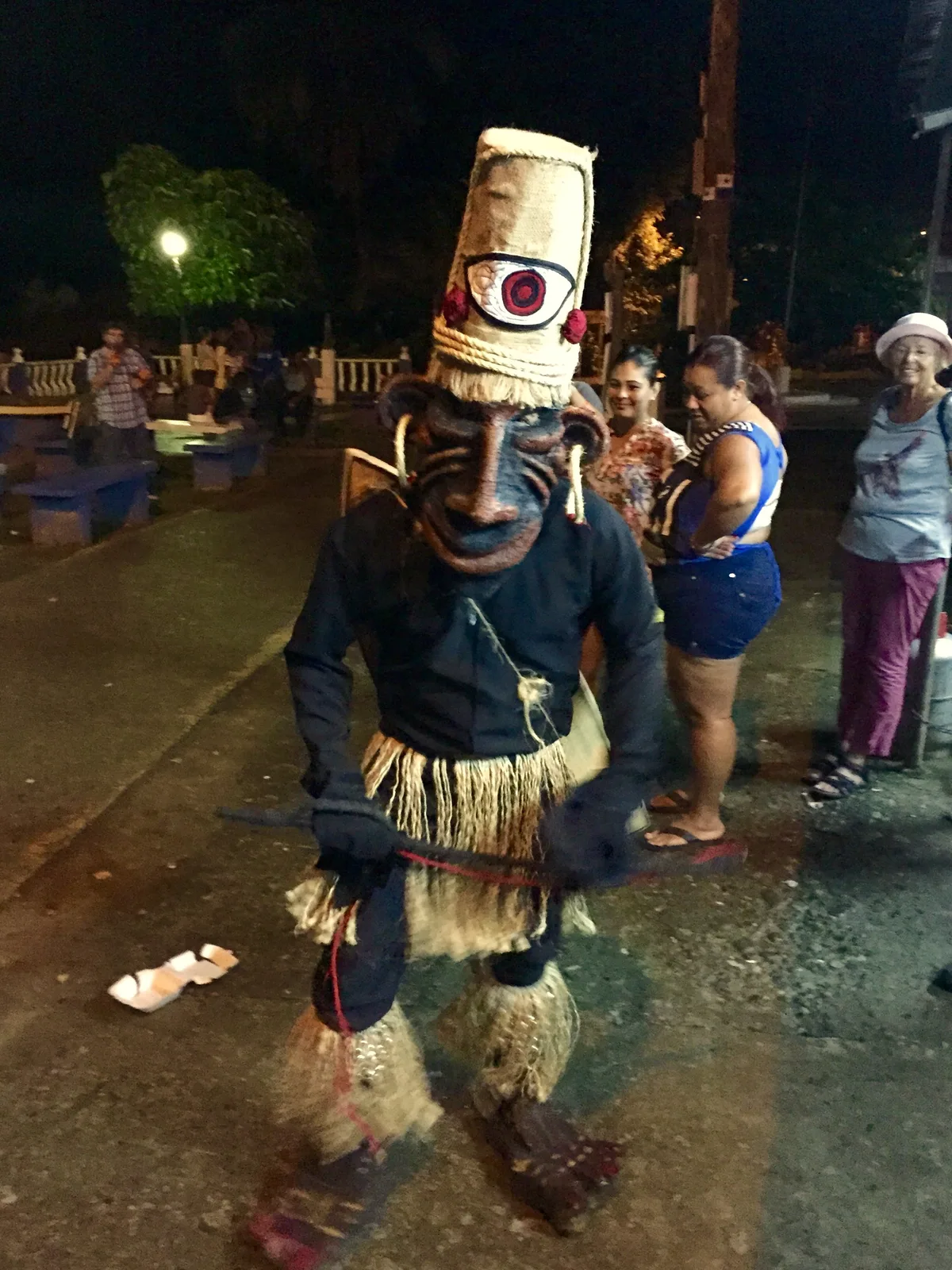 A costumed performer towering over the crowd during a street parade