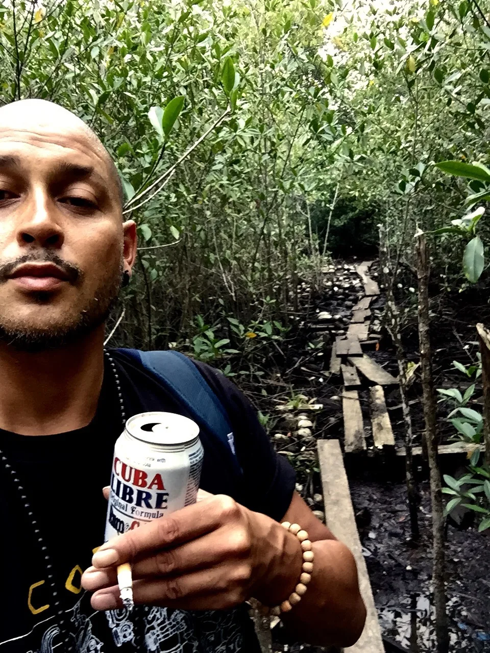A traveller with a drink in hand on a Central America street
