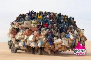 An overloaded truck piled high with cargo