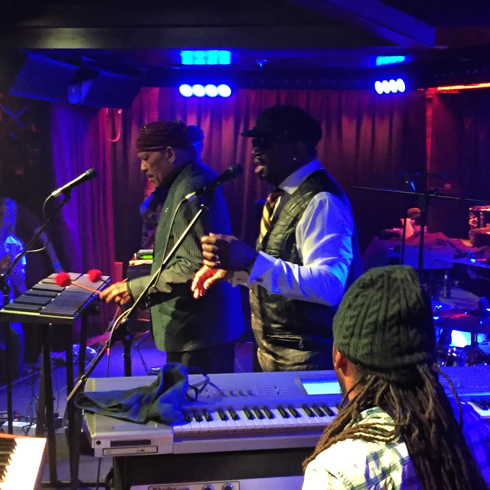 A brass band playing live on stage at the Jam Gallery