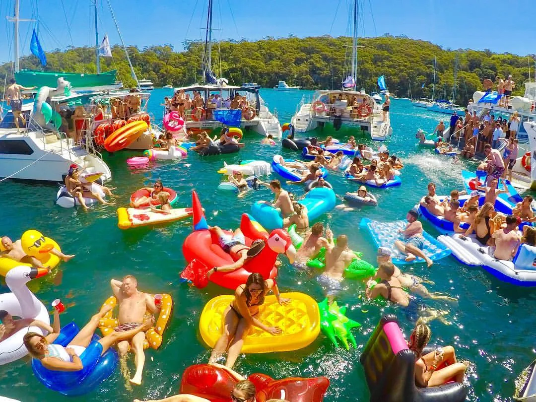 Boats rafted together with brightly coloured inflatables at the Yacht Club Social party