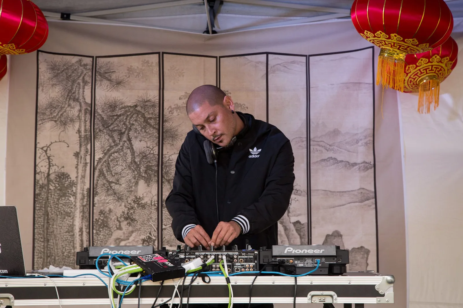 A DJ playing at the Chinese New Year festival with lanterns behind