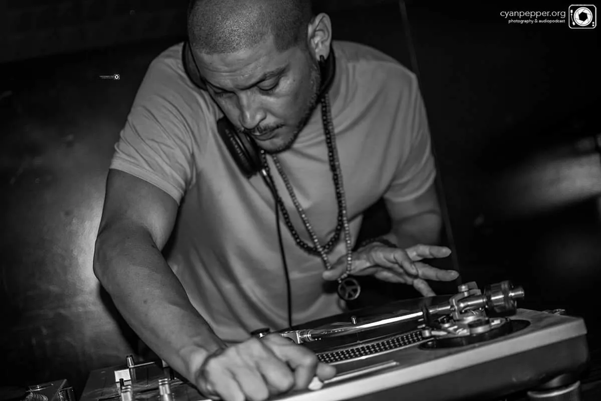 DJ CMAN mixing on the turntables, close up, black and white