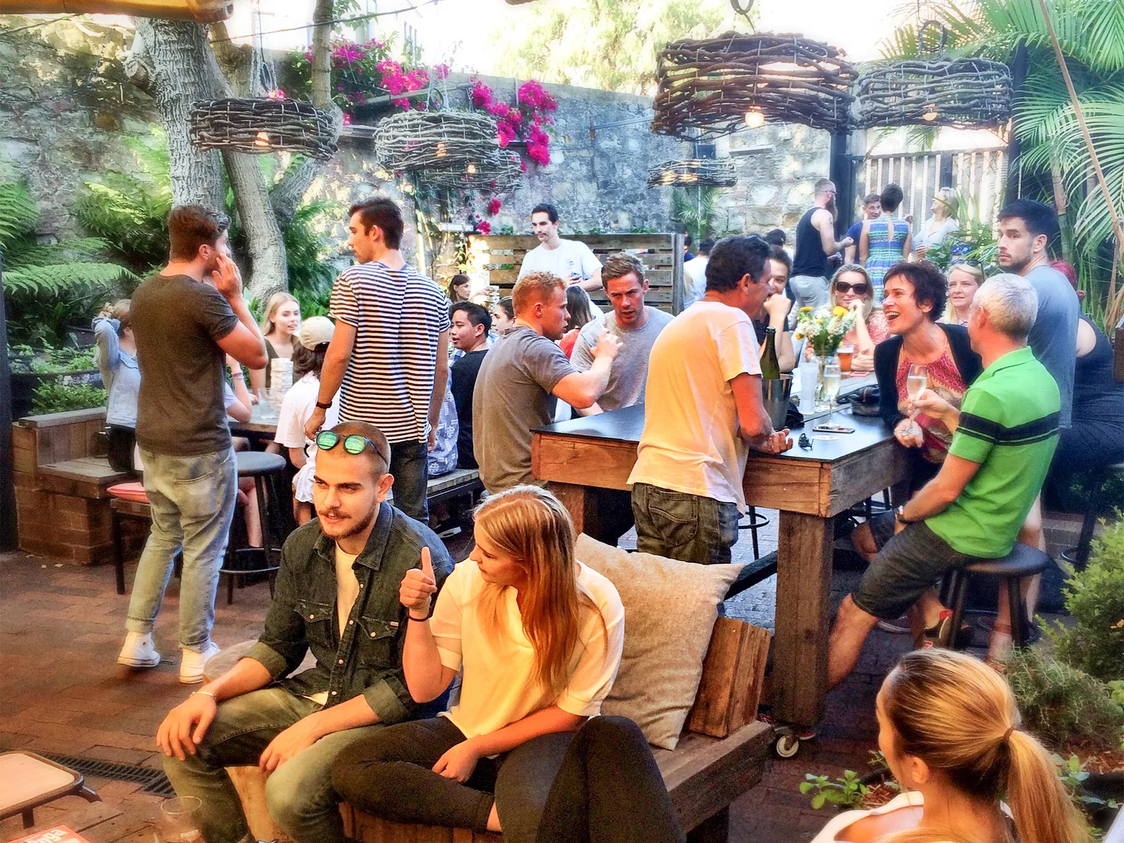 Crowd at tables in the beer garden at Dick's Hotel Balmain on a sunny afternoon