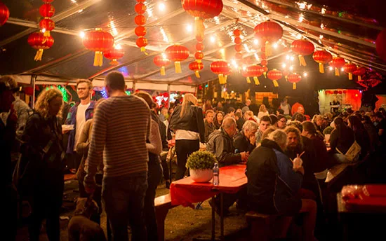 A busy night hawker market strung with red lanterns