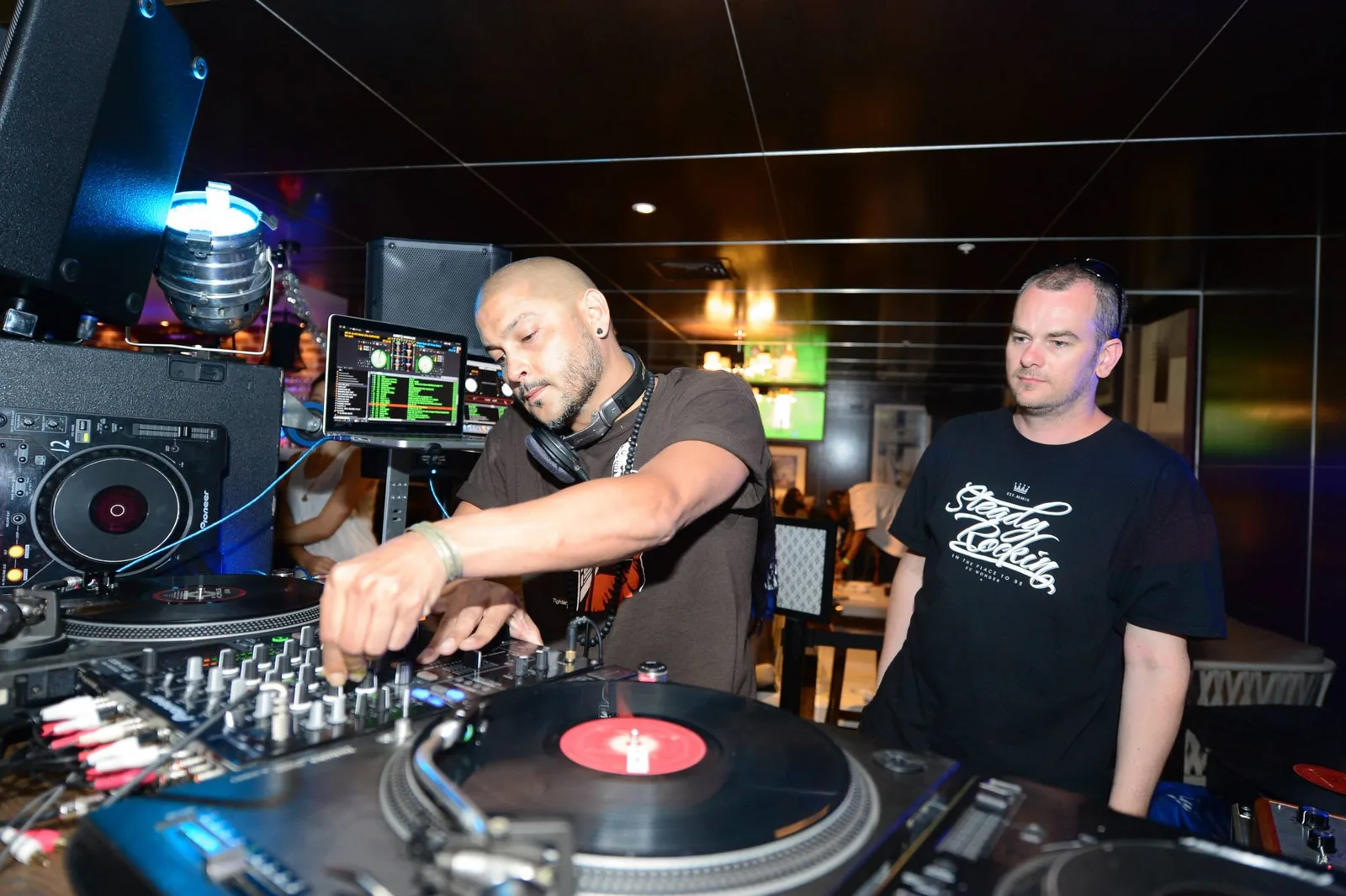 Two DJs sharing the booth at Dick's Hotel