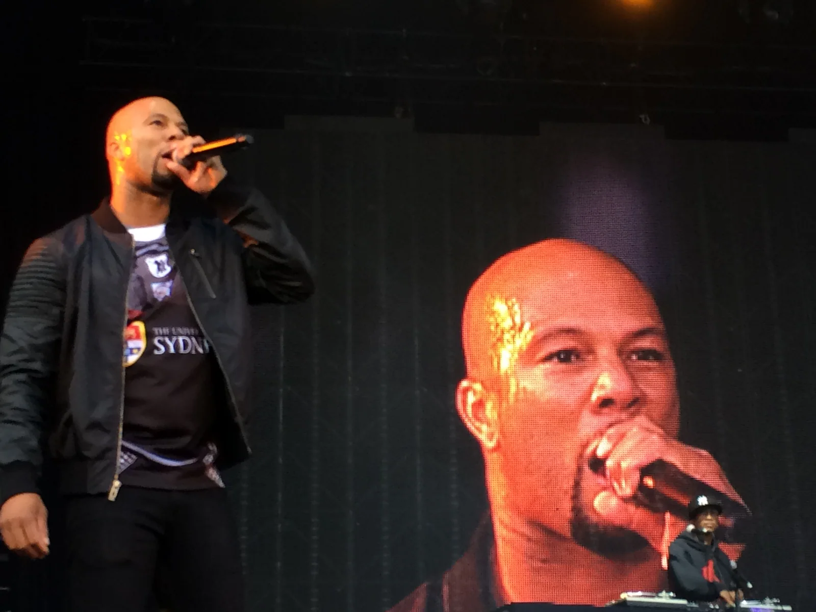 Common rapping on the Soulfest stage with his face on the giant screen behind and his DJ at the decks