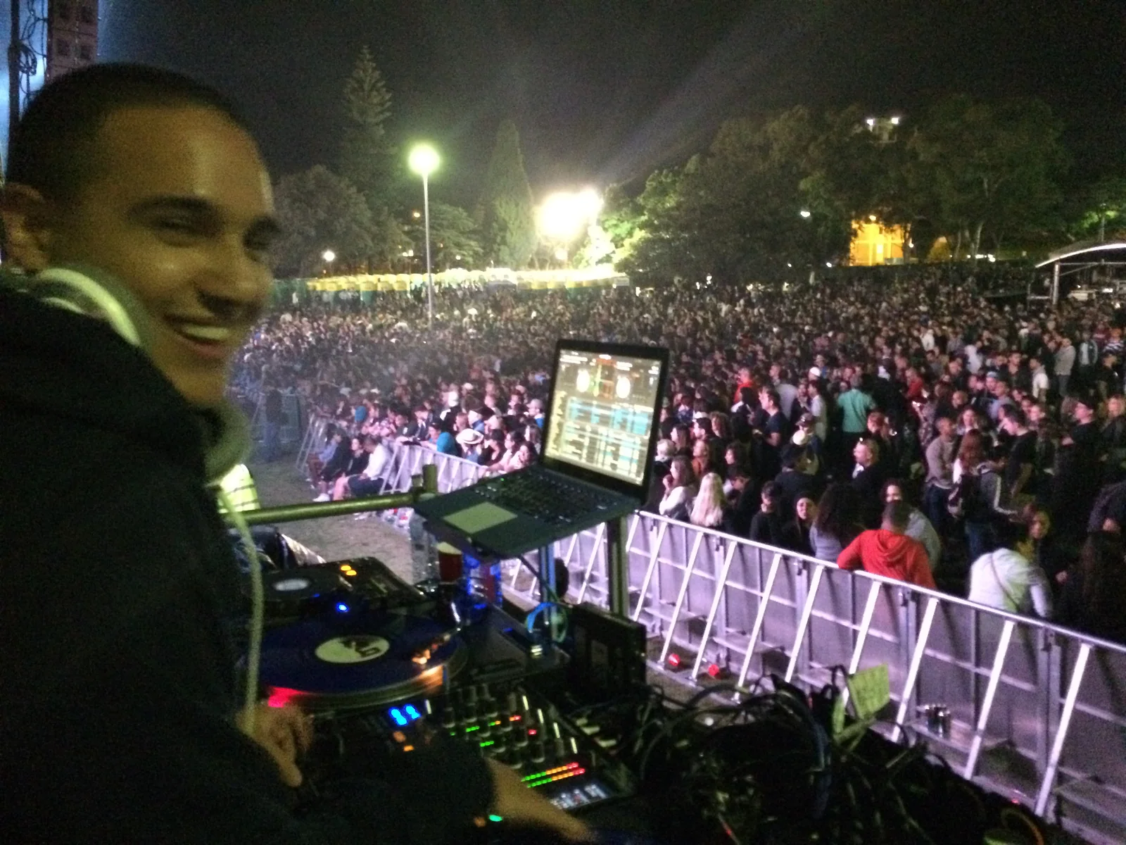 Grinning back from the night-time DJ booth over a packed Victoria Park crowd, laptop screen glowing