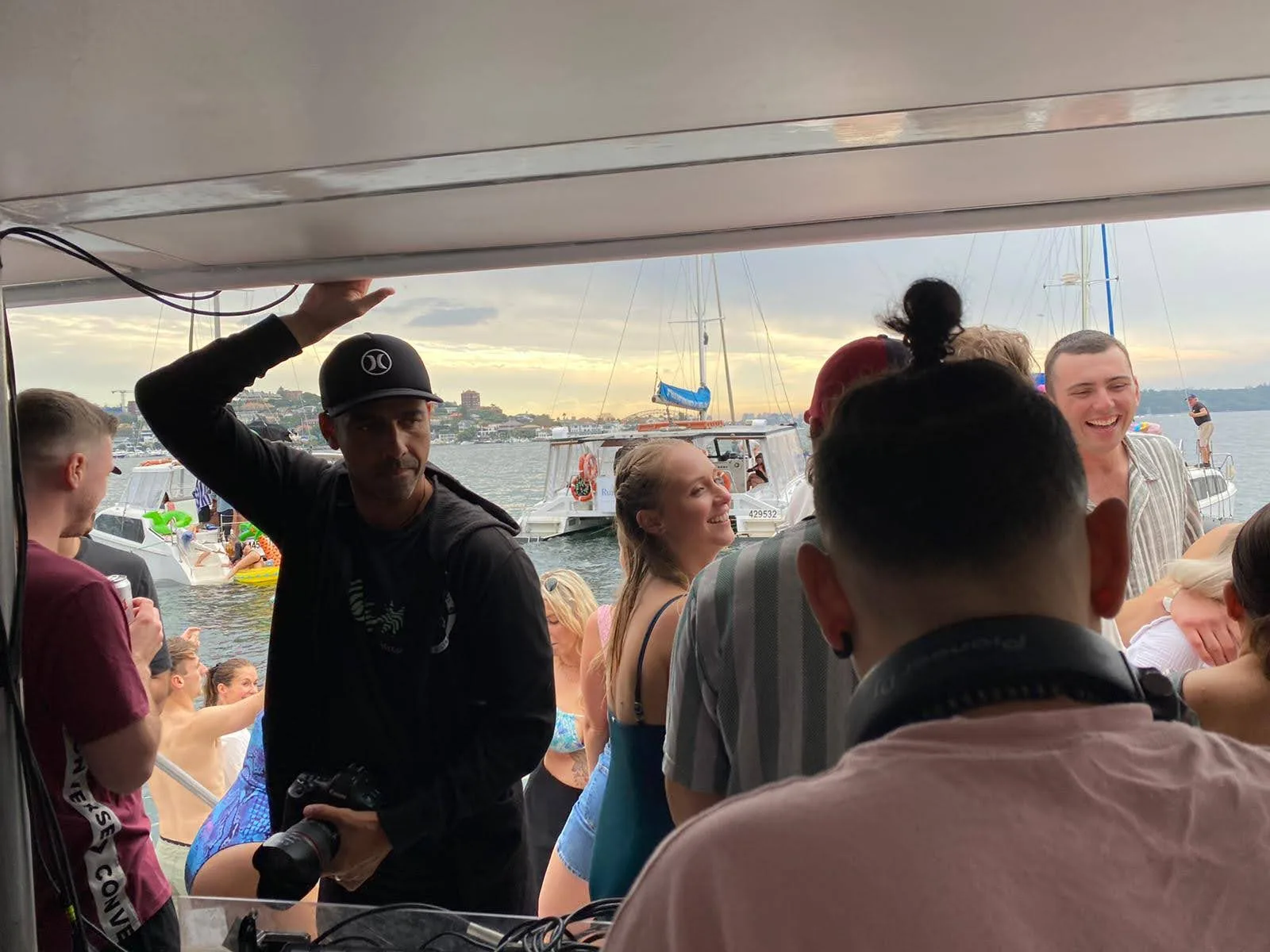 DJ CMAN from behind, head down over the decks at The Yacht Social Club on Sydney Harbour.