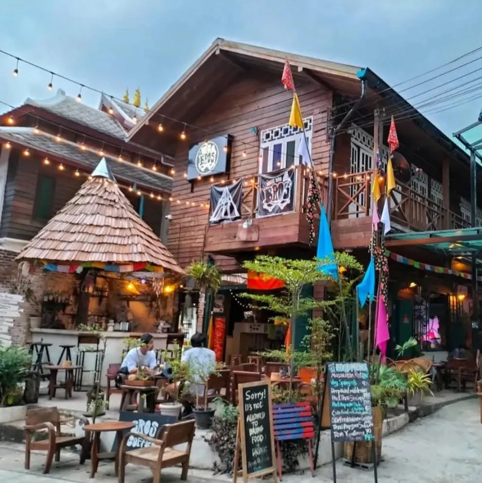 Bros Music Bar on the main street of Pai, Thailand — wooden open-air live music venue with string lights and flags
