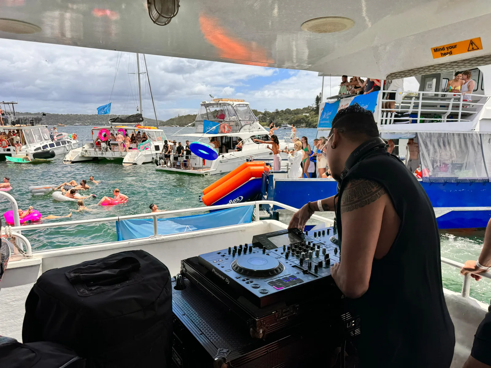 DJ CMAN playing aboard The Yacht Social Club DJ boat on Sydney Harbour.